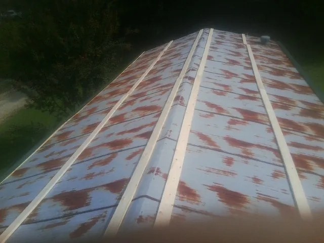 Rusted metal roof panels with new wood purlins before replacement — Storm Damage Roof Repair in Murrieta by Roofing Brothers