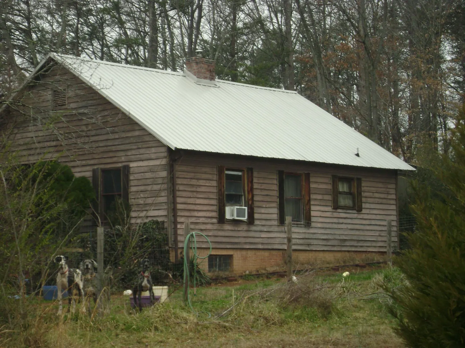 White metal roof on an old wood sided farmhouse, from a Metal Roof Installation job in Murrieta